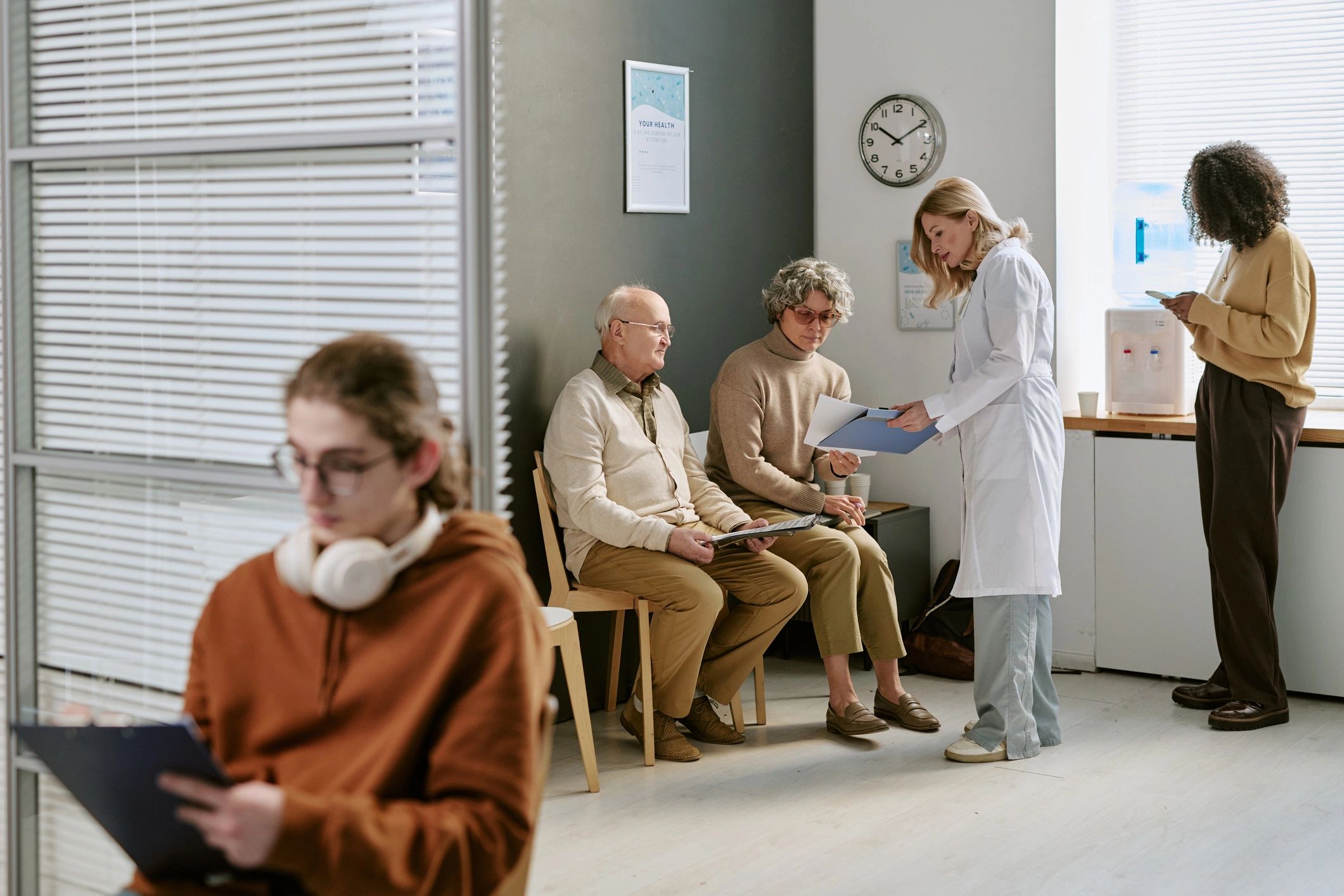 Doctor consulting with patients in clinic